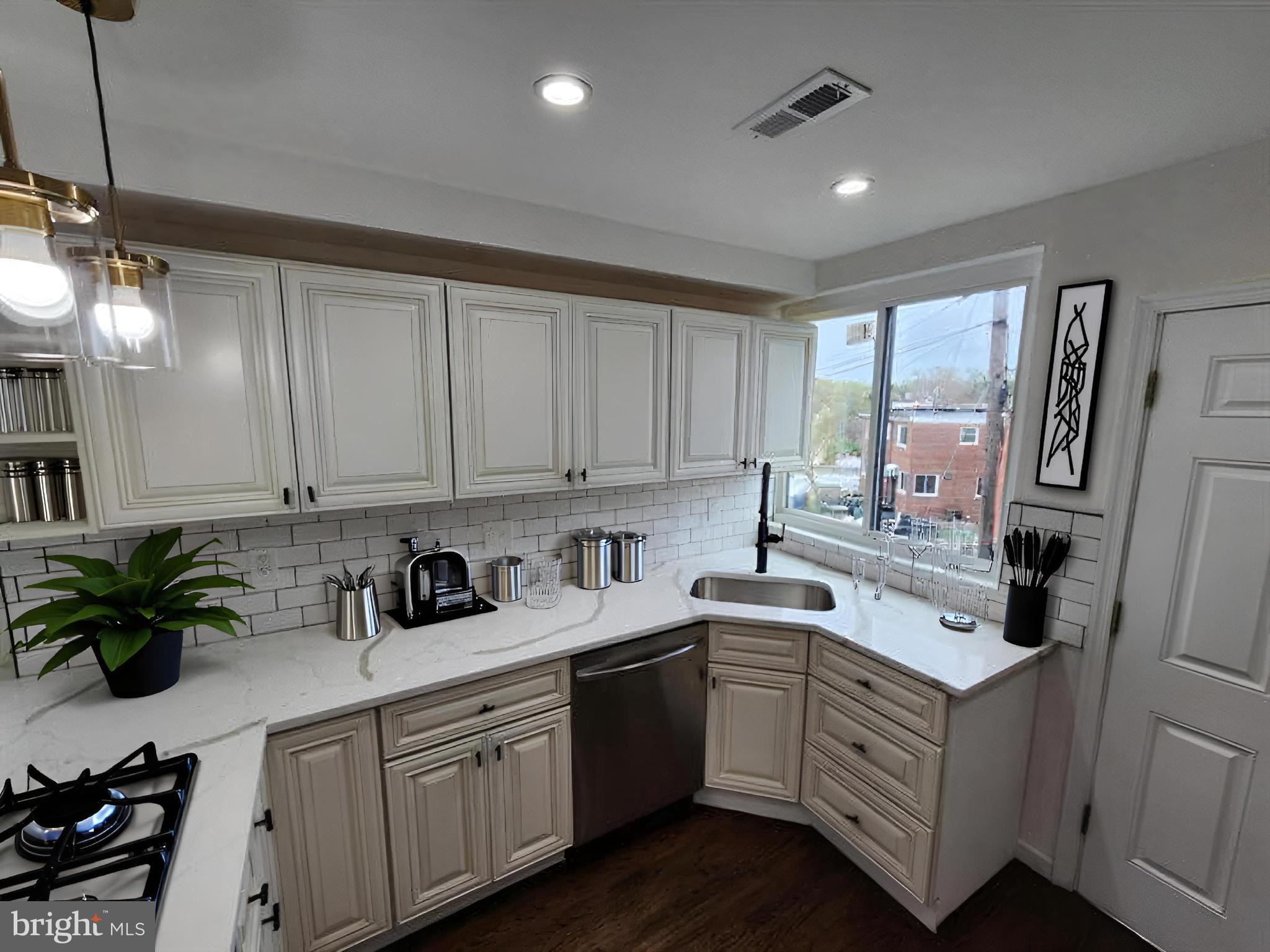 1261 Gallatin Street Northeast Washington, DC 20017 - Photo 11 of 60 a kitchen with a sink stove and cabinets