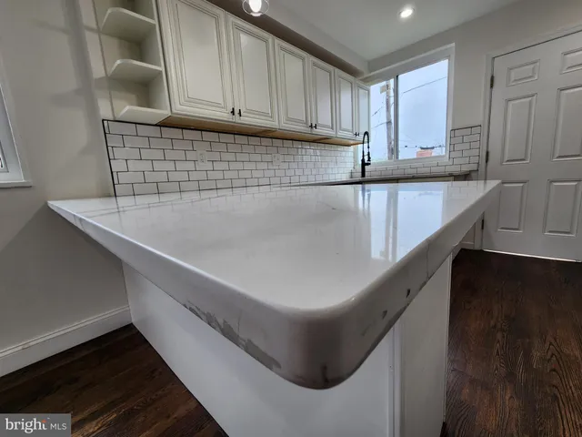 a kitchen with granite countertop a stove and a refrigerator
