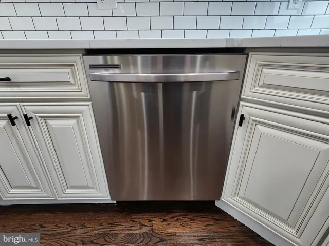 a spacious bedroom with a bed and a chandelier