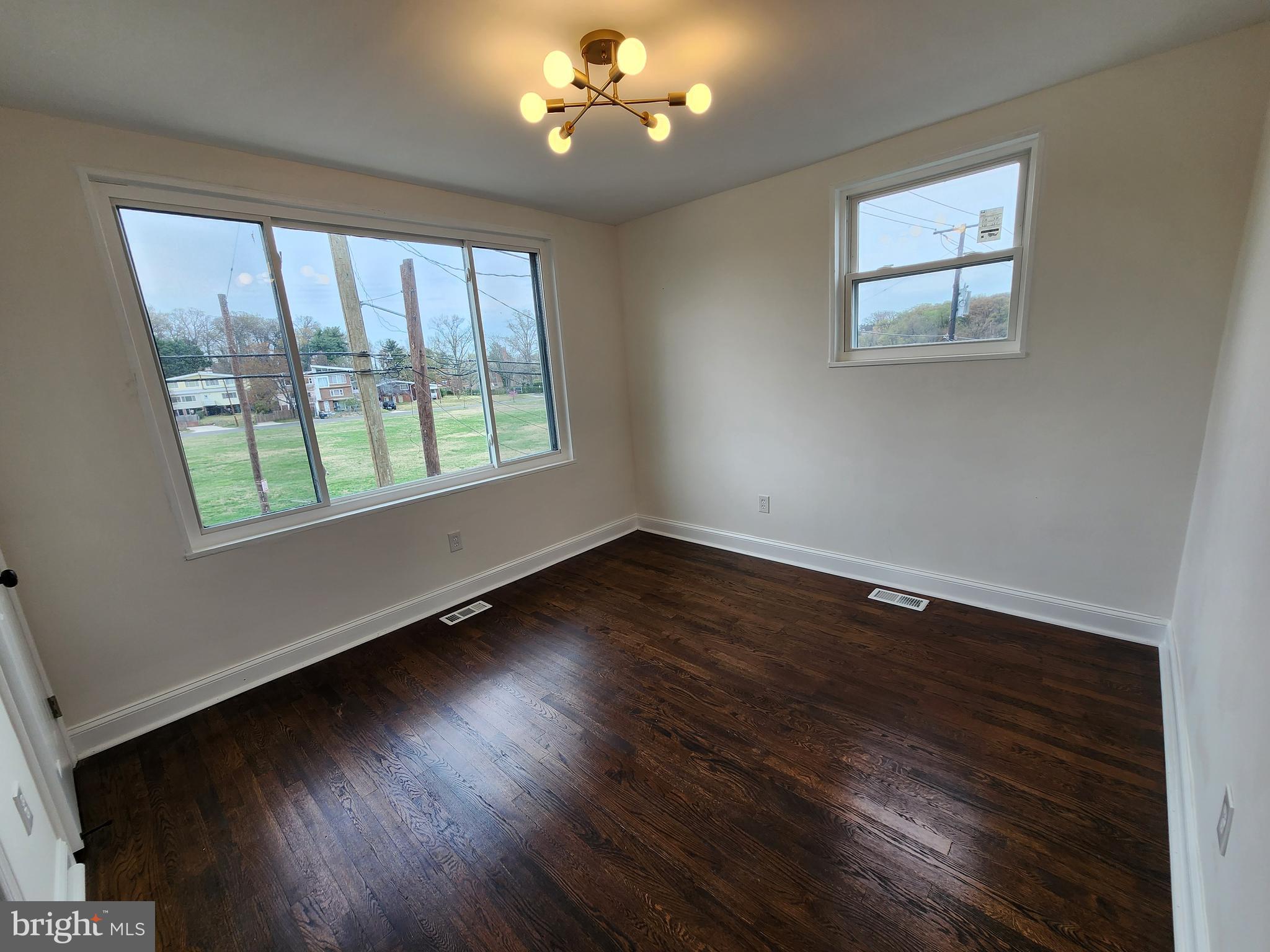 1261 Gallatin Street Northeast Washington, DC 20017 - Photo 20 of 60 a view of an empty room with wooden floor and a window