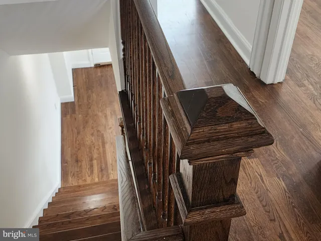a view of wooden floor chandelier and window in a room