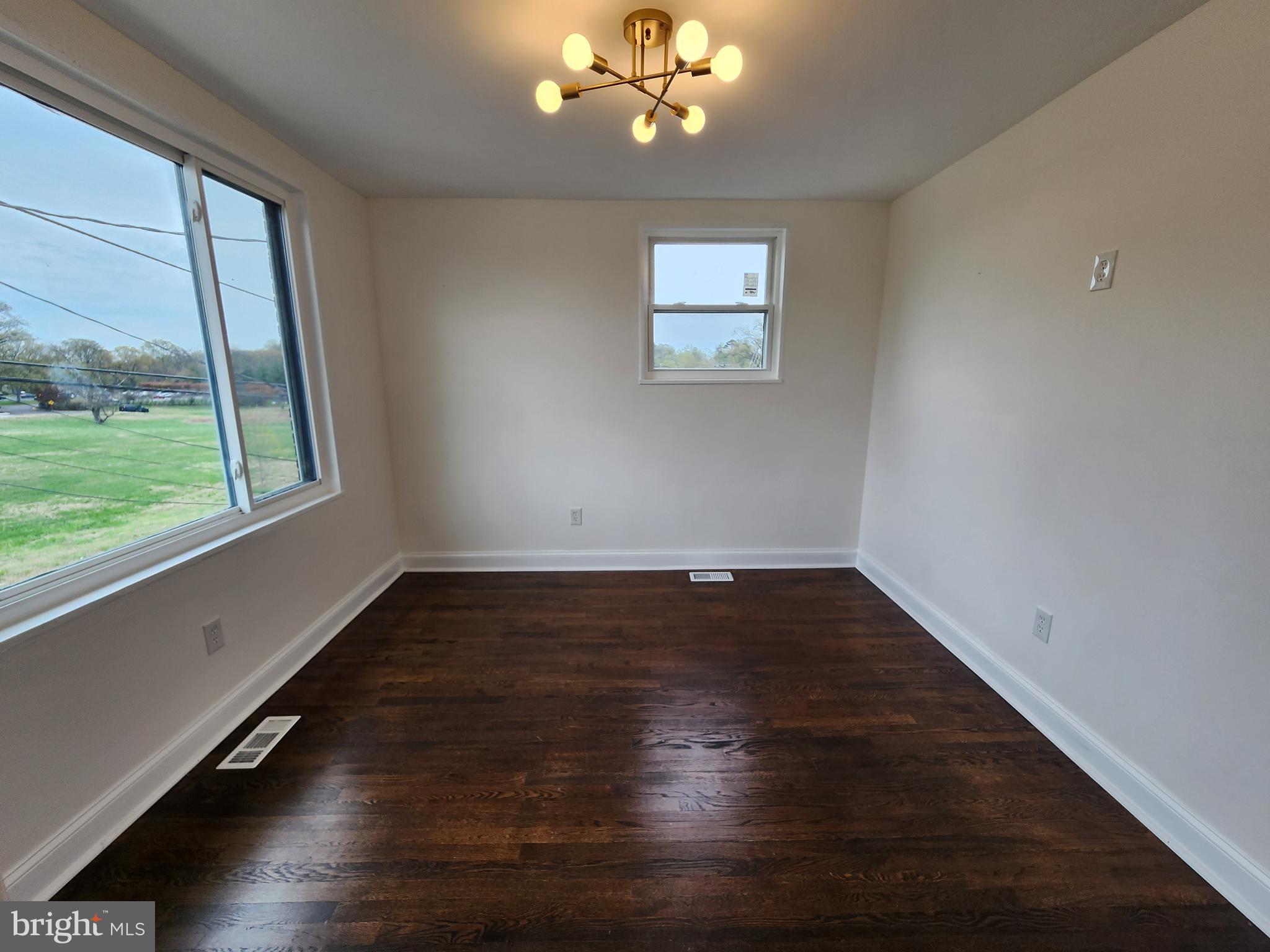 1261 Gallatin Street Northeast Washington, DC 20017 - Photo 28 of 60 an empty room with wooden floor and windows