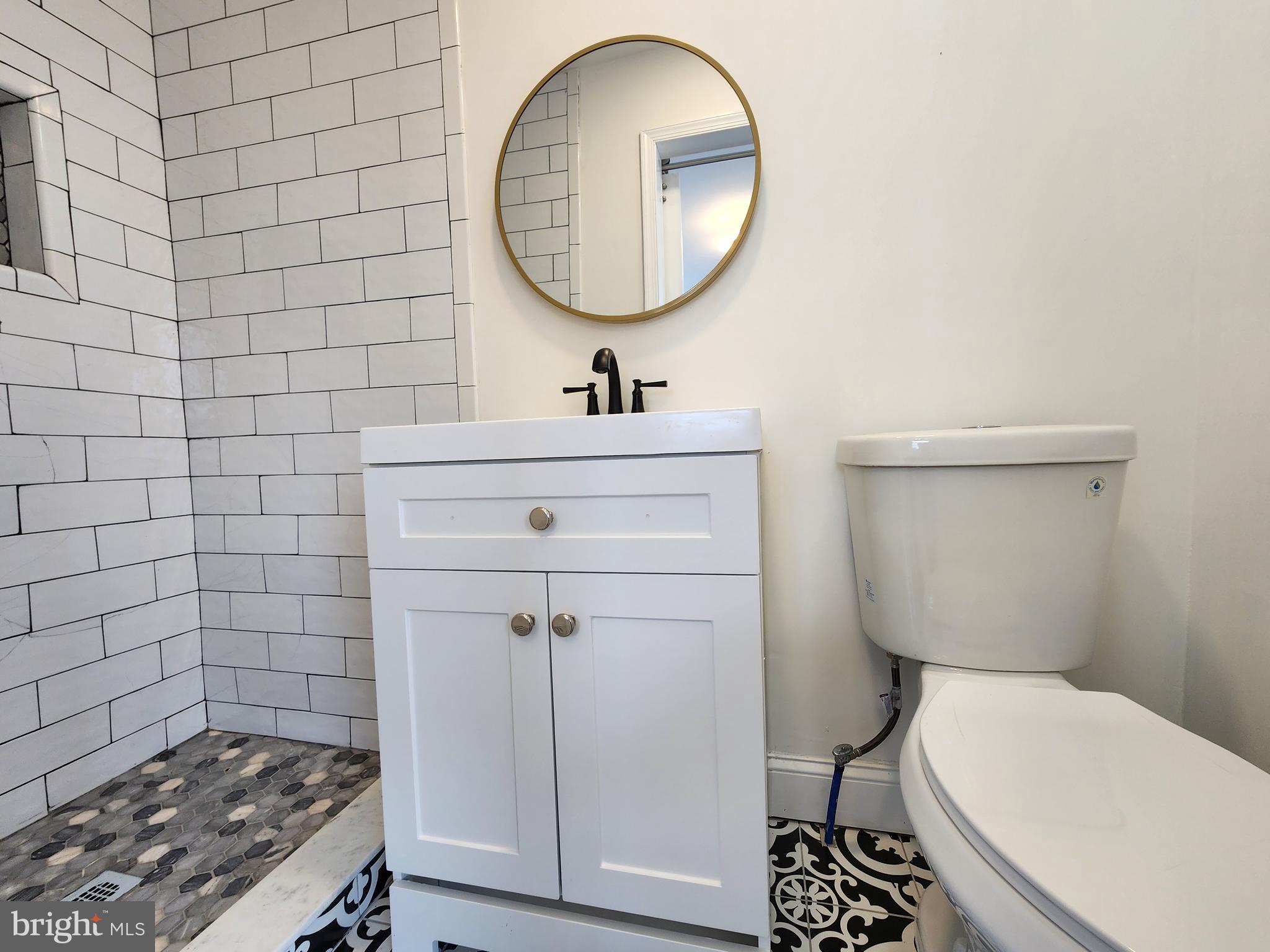 1261 Gallatin Street Northeast Washington, DC 20017 - Photo 30 of 60 a bathroom with a toilet a sink and mirror