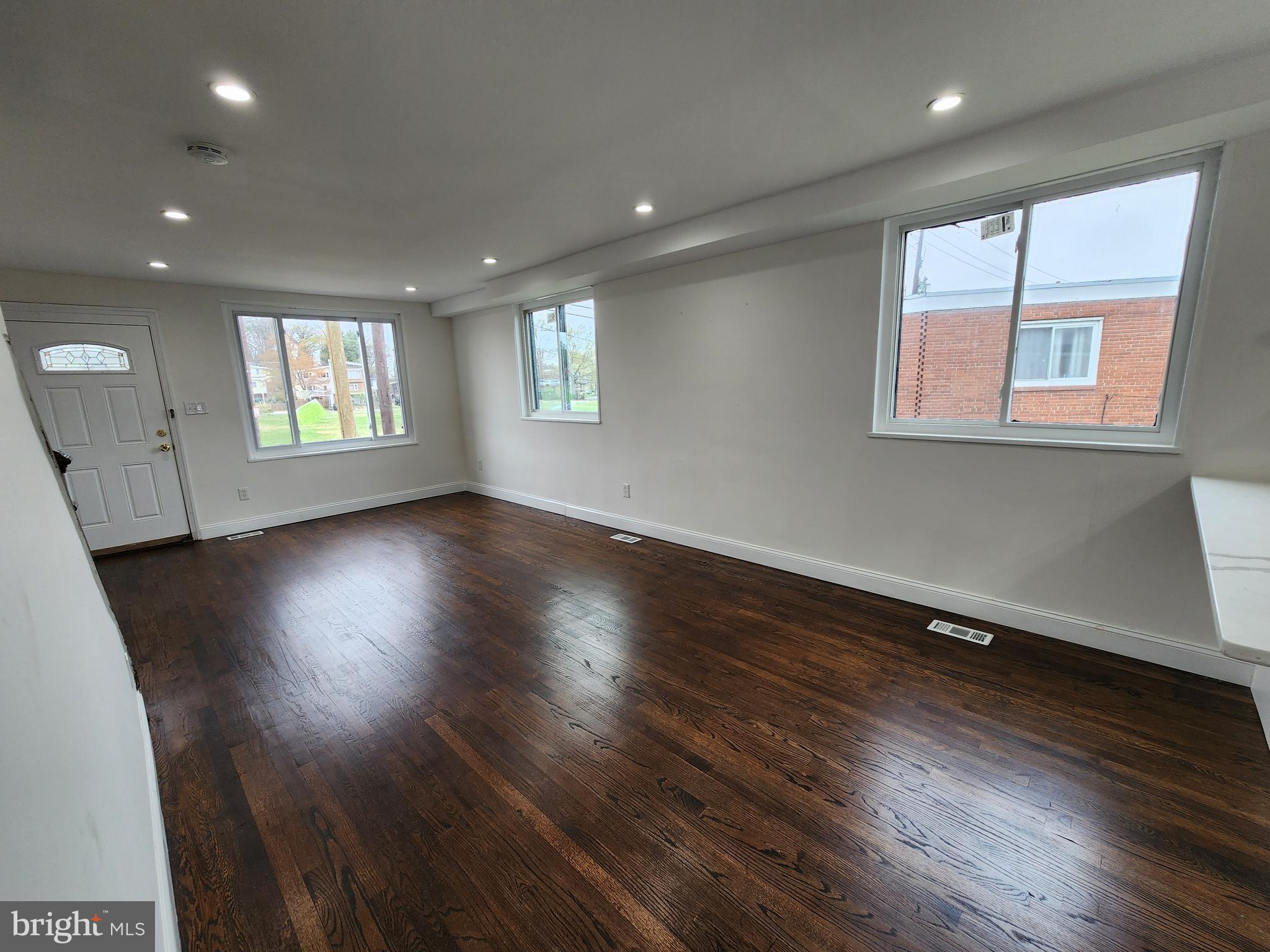 1261 Gallatin Street Northeast Washington, DC 20017 - Photo 35 of 60 an empty room with wooden floor and windows