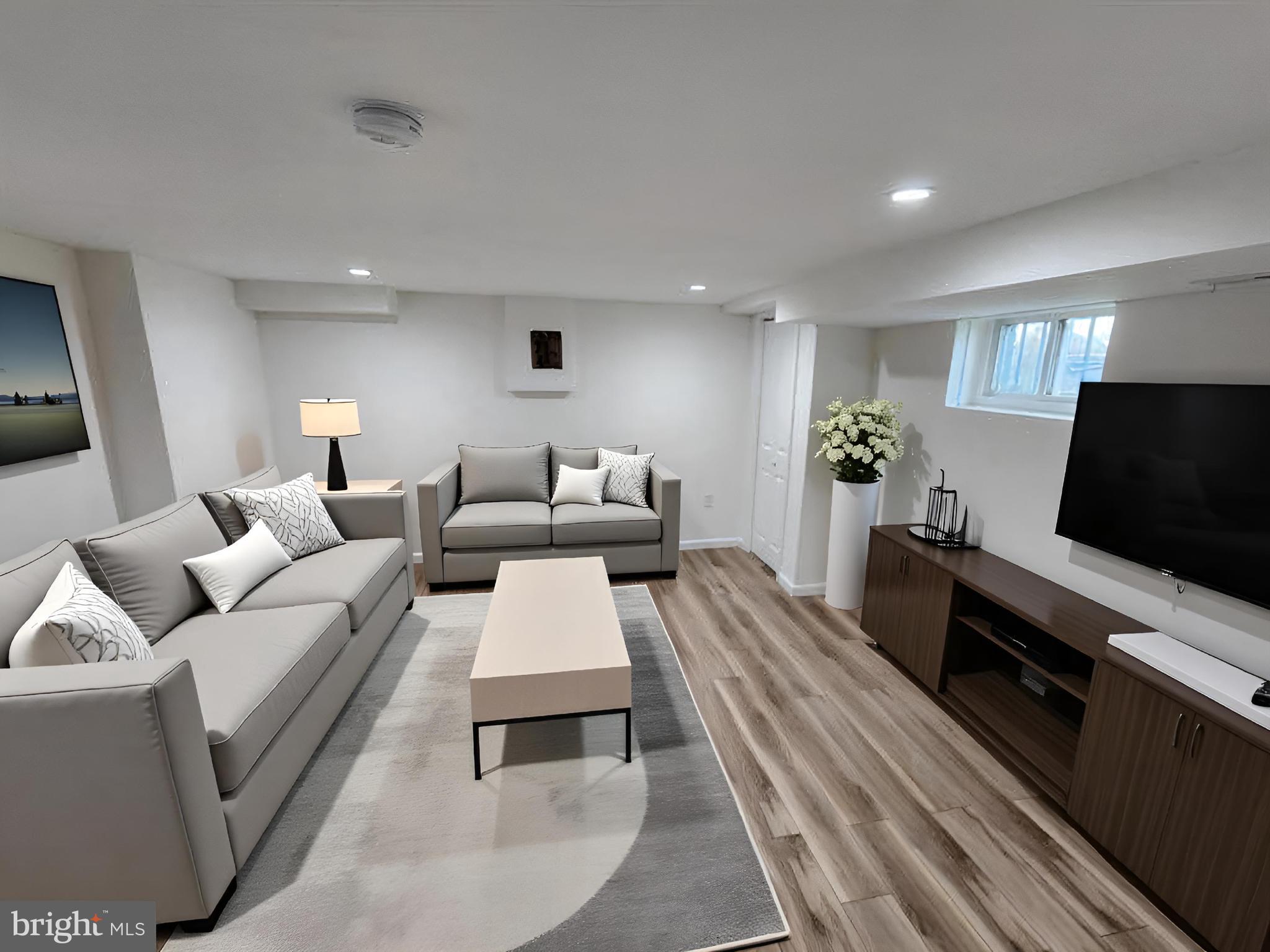 1261 Gallatin Street Northeast Washington, DC 20017 - Photo 37 of 60 a living room with furniture and a flat screen tv