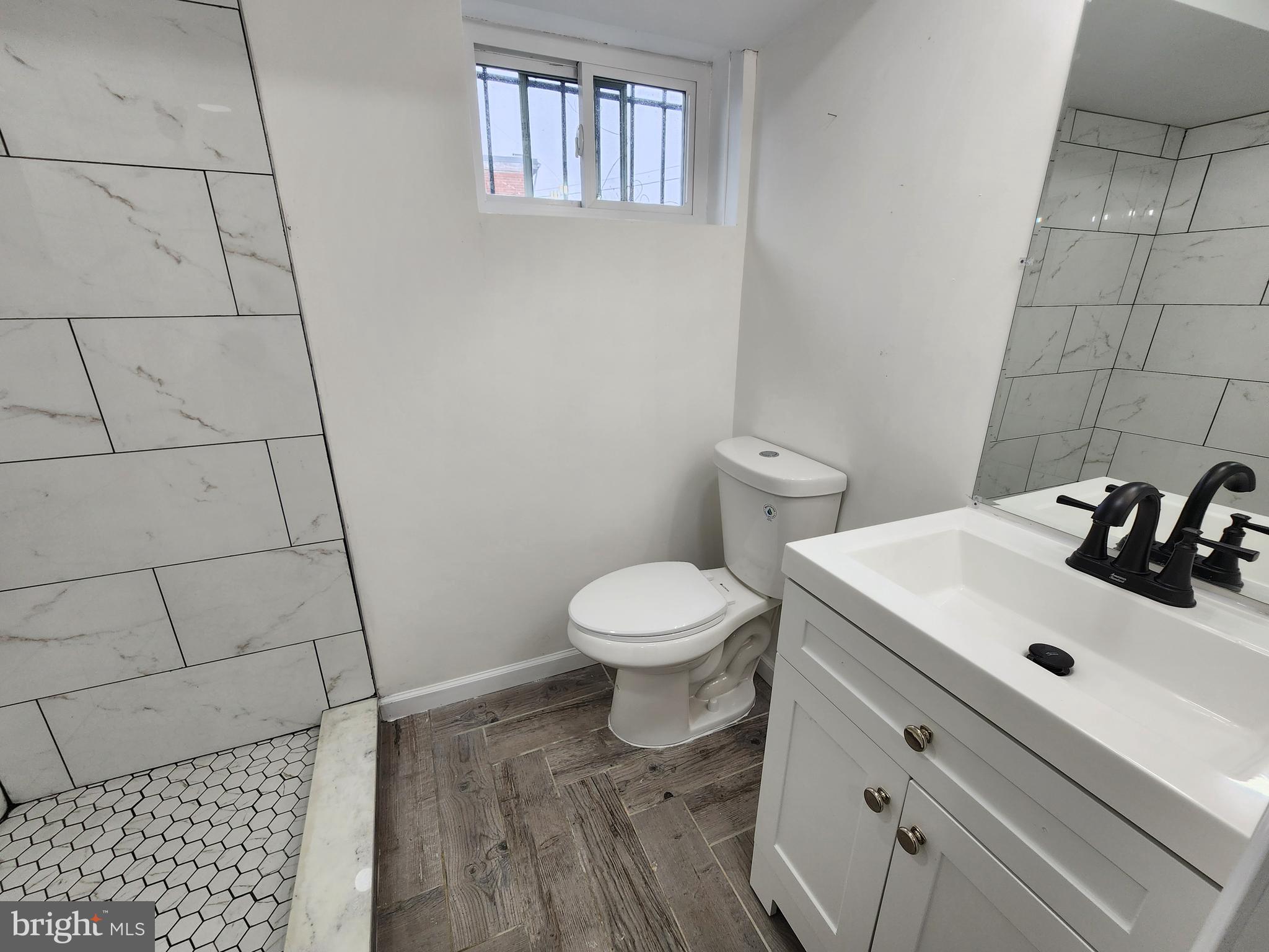 1261 Gallatin Street Northeast Washington, DC 20017 - Photo 40 of 60 a bathroom with a sink toilet and a mirror