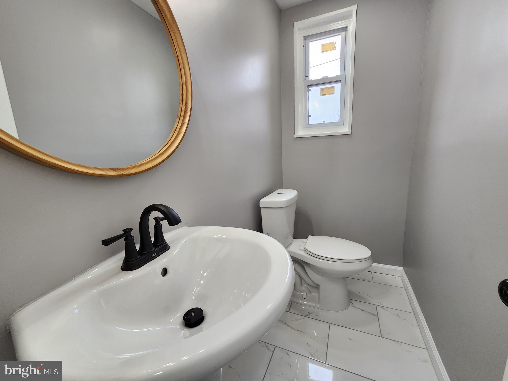1261 Gallatin Street Northeast Washington, DC 20017 - Photo 43 of 60 a bathroom with a sink a toilet and mirror
