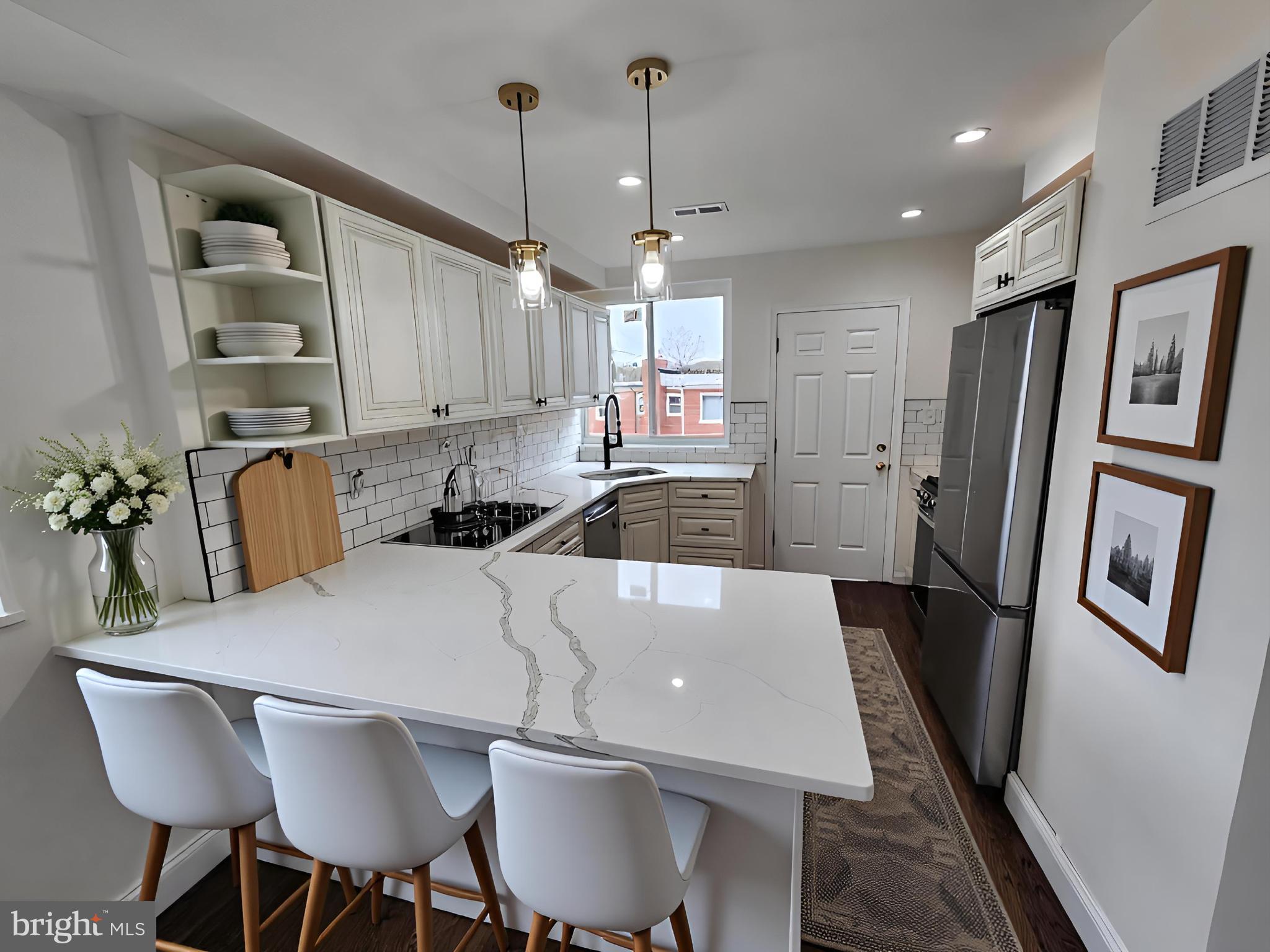 1261 Gallatin Street Northeast Washington, DC 20017 - Photo 6 of 60 a kitchen with stainless steel appliances granite countertop a refrigerator a sink a stove a dining table and chairs