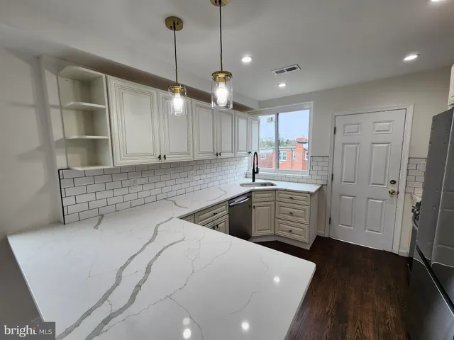 a kitchen with lot of cabinets and window