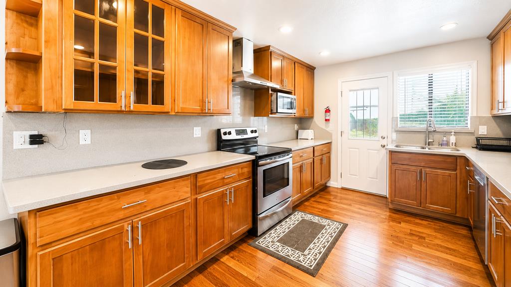 1281 Traynor Road Concord, CA 94520 - Photo 11 of 41 a kitchen with stainless steel appliances granite countertop a stove a sink and a microwave
