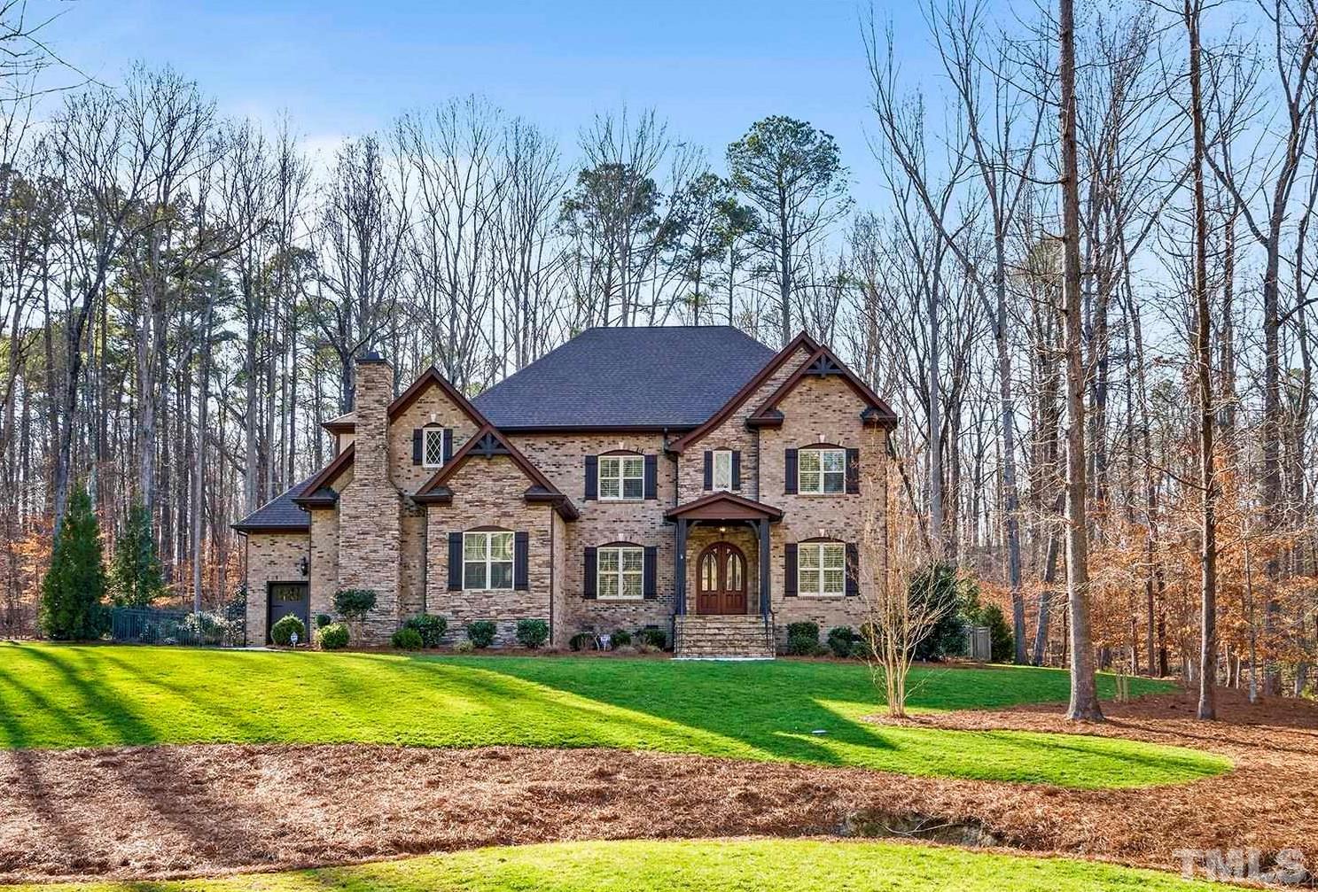 6837 Mactavish Way Raleigh, NC 27613 - Photo 1 of 48 a view of a big house with a big yard and large trees