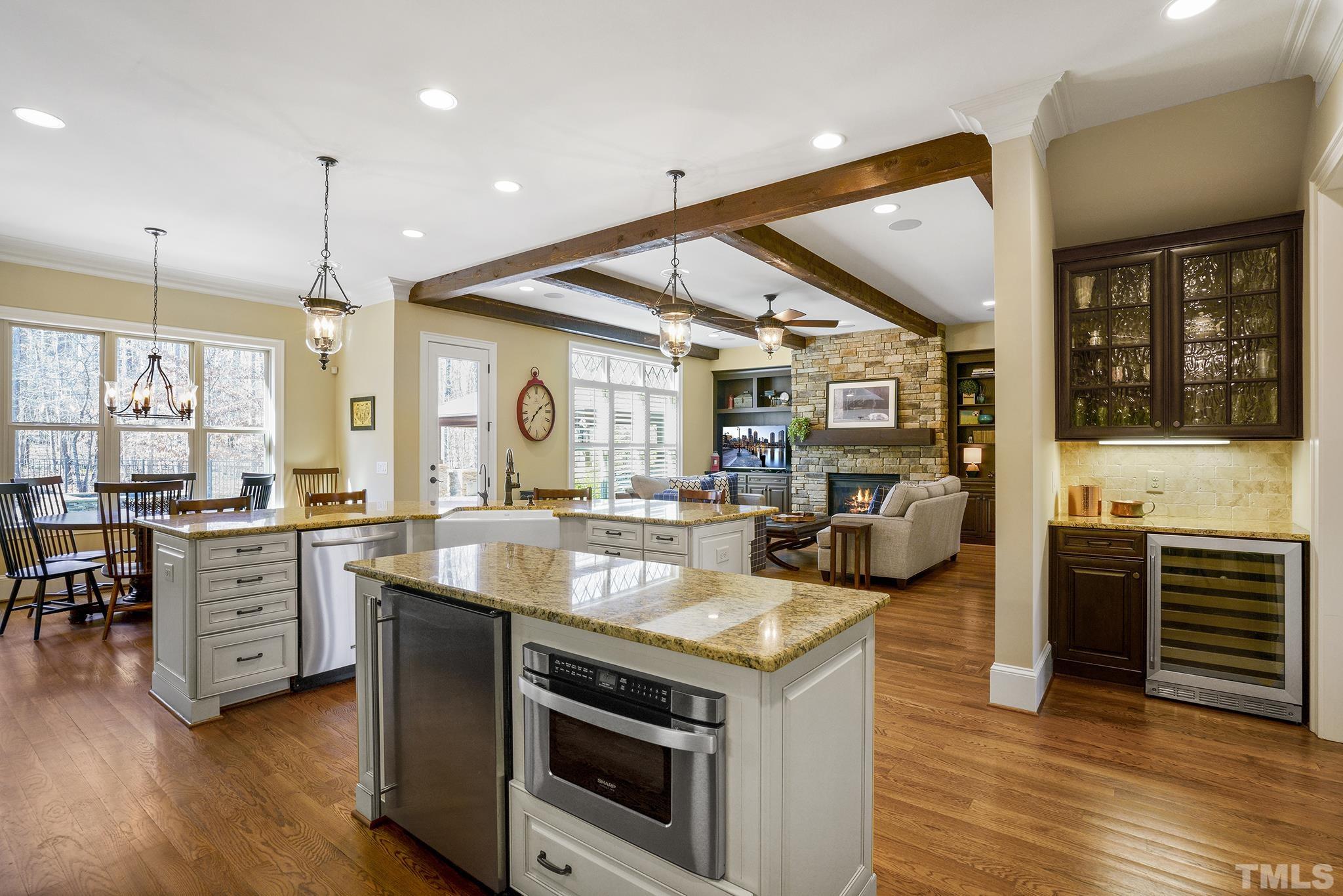 6837 Mactavish Way Raleigh, NC 27613 - Photo 15 of 48 a kitchen with a stove and a wooden floor