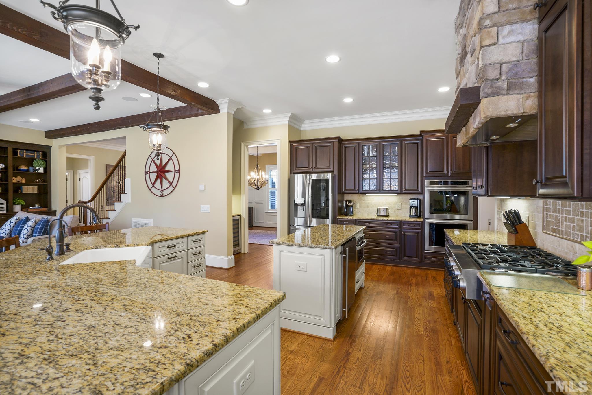 6837 Mactavish Way Raleigh, NC 27613 - Photo 16 of 48 a kitchen with stainless steel appliances granite countertop a sink stove and refrigerator