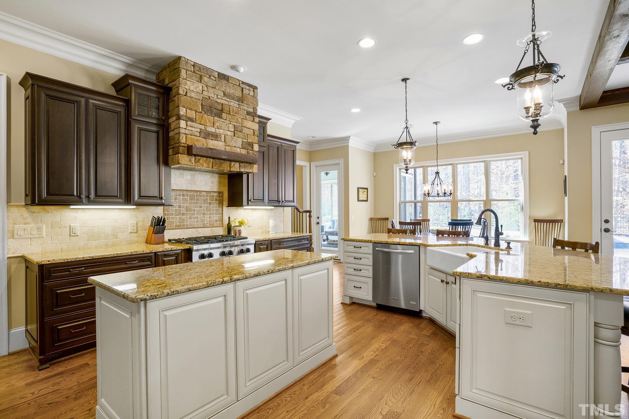 6837 Mactavish Way Raleigh, NC 27613 - Photo 18 of 48 a kitchen with a stove a sink and a refrigerator
