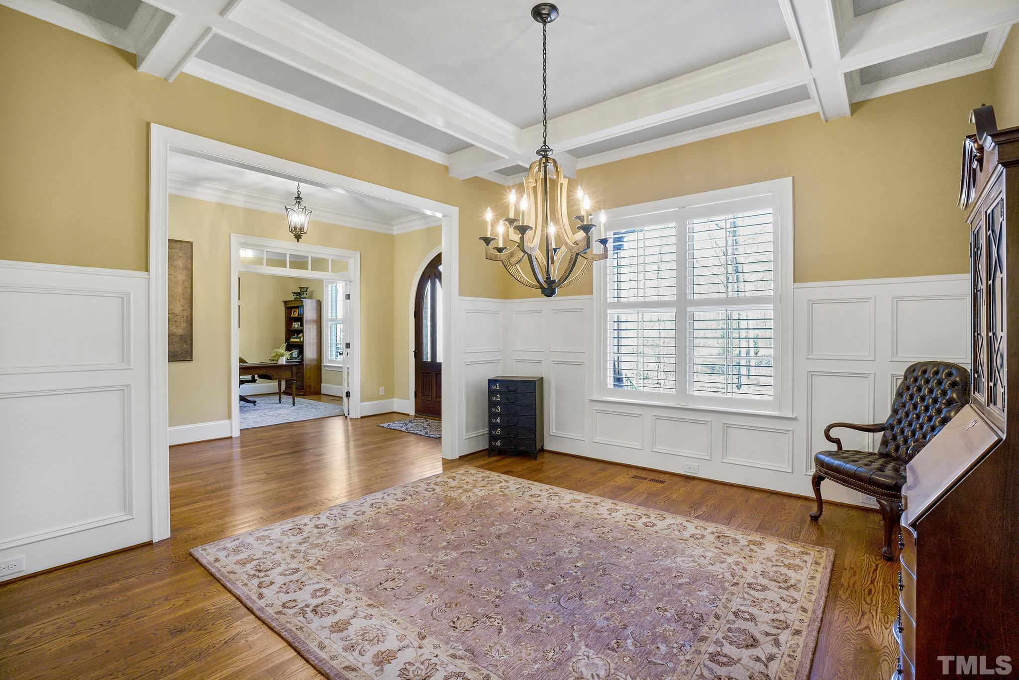 6837 Mactavish Way Raleigh, NC 27613 - Photo 23 of 48 a living room with fireplace furniture and a chandelier