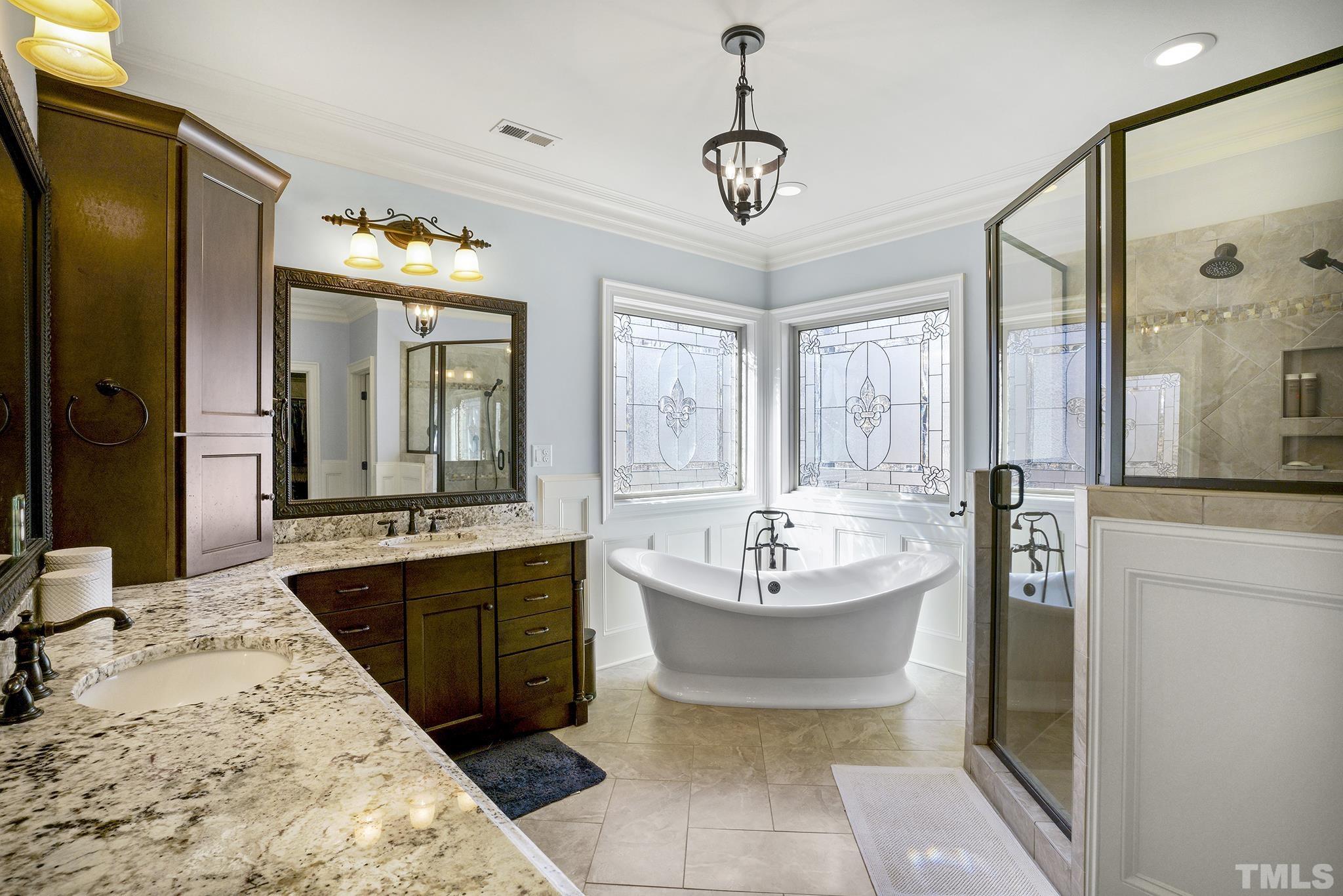 6837 Mactavish Way Raleigh, NC 27613 - Photo 26 of 48 a large bathroom with a double vanity sink mirror and bathtub