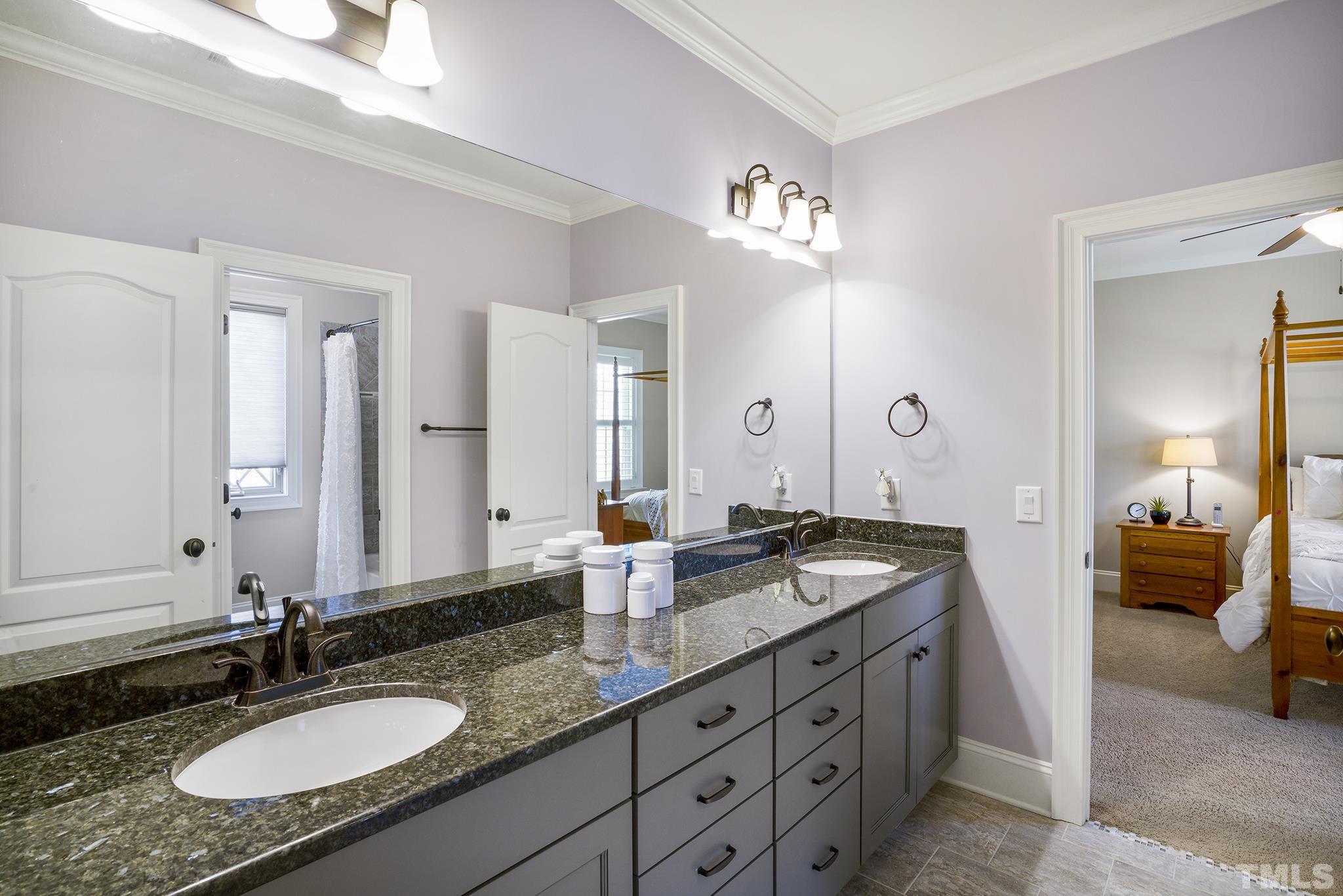 6837 Mactavish Way Raleigh, NC 27613 - Photo 29 of 48 a en suite bathroom with double sink and a mirror