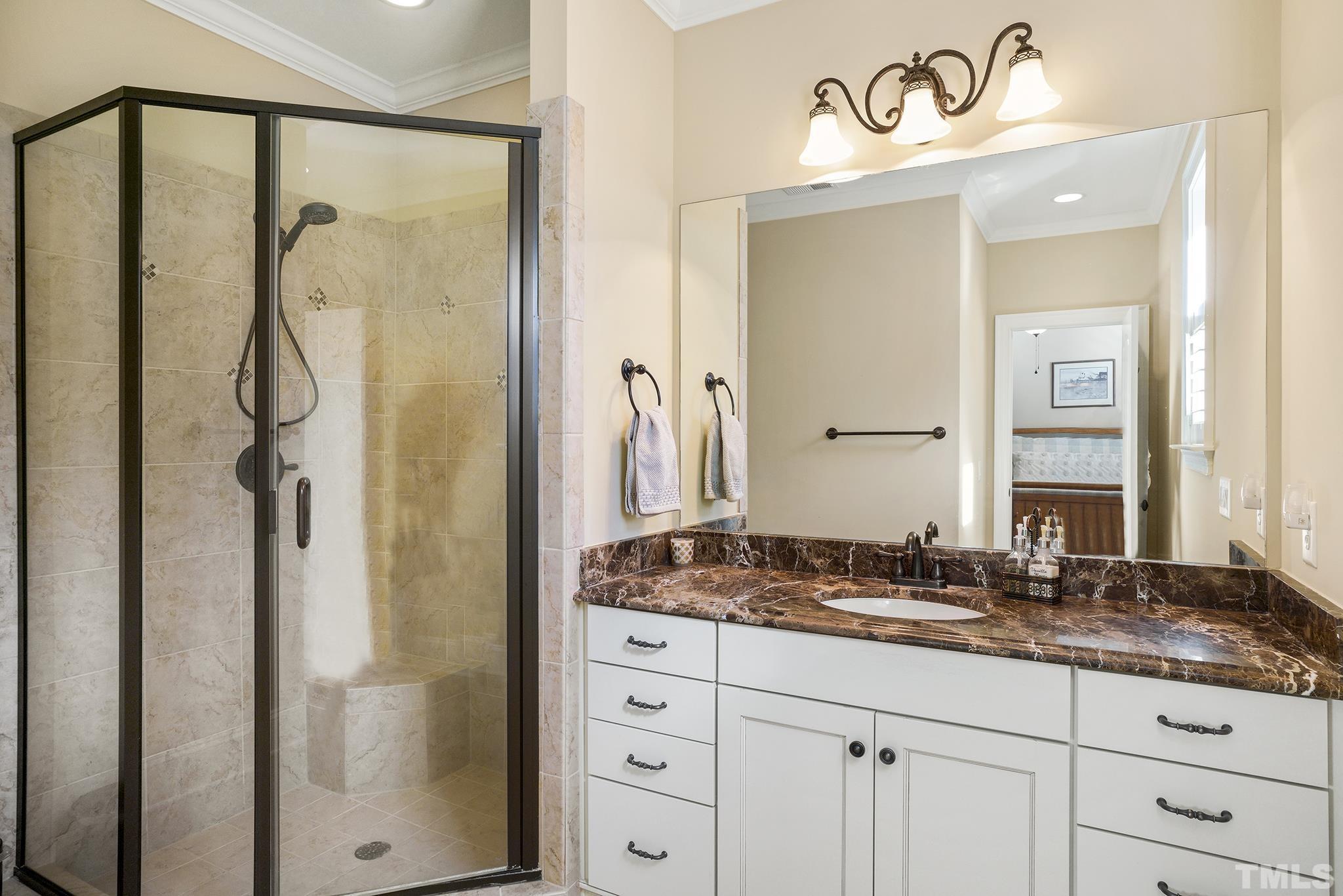 6837 Mactavish Way Raleigh, NC 27613 - Photo 32 of 48 a bathroom with a granite countertop sink and a mirror