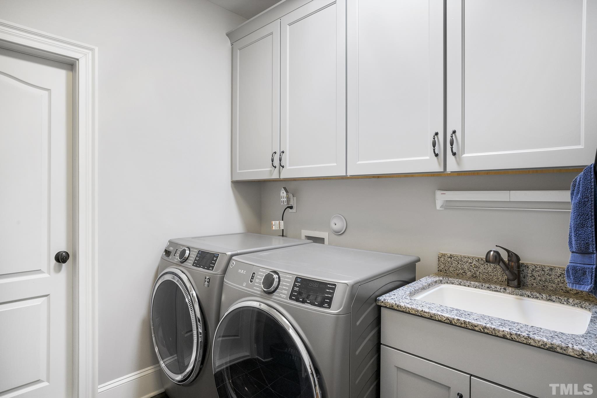 6837 Mactavish Way Raleigh, NC 27613 - Photo 33 of 48 a view of storage and utility room with washer and dryer