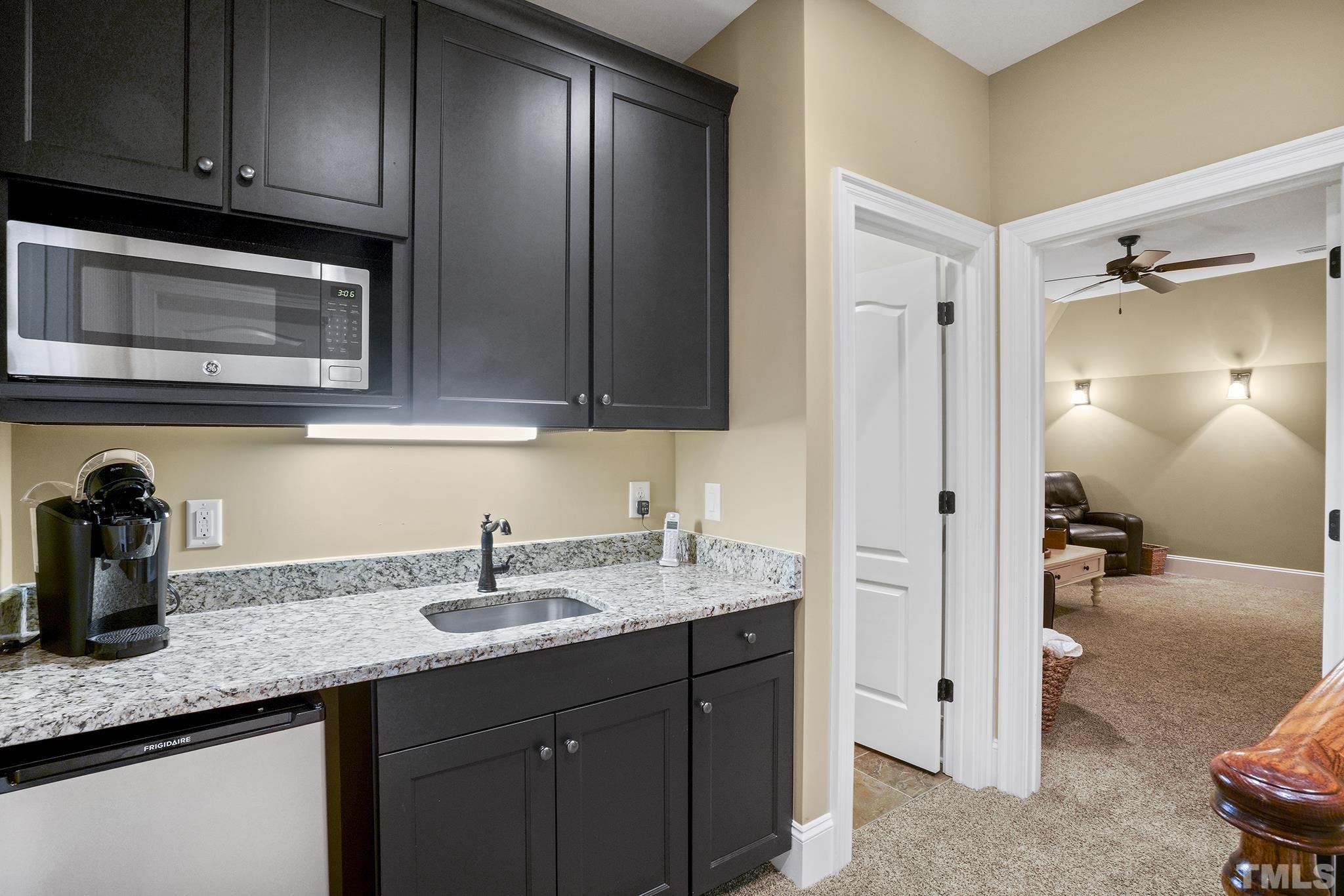 6837 Mactavish Way Raleigh, NC 27613 - Photo 36 of 48 a kitchen with sink a refrigerator and cabinets