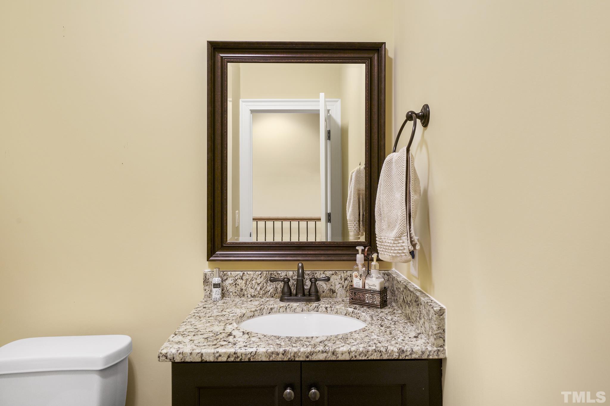 6837 Mactavish Way Raleigh, NC 27613 - Photo 38 of 48 a bathroom with a granite countertop sink and a toilet