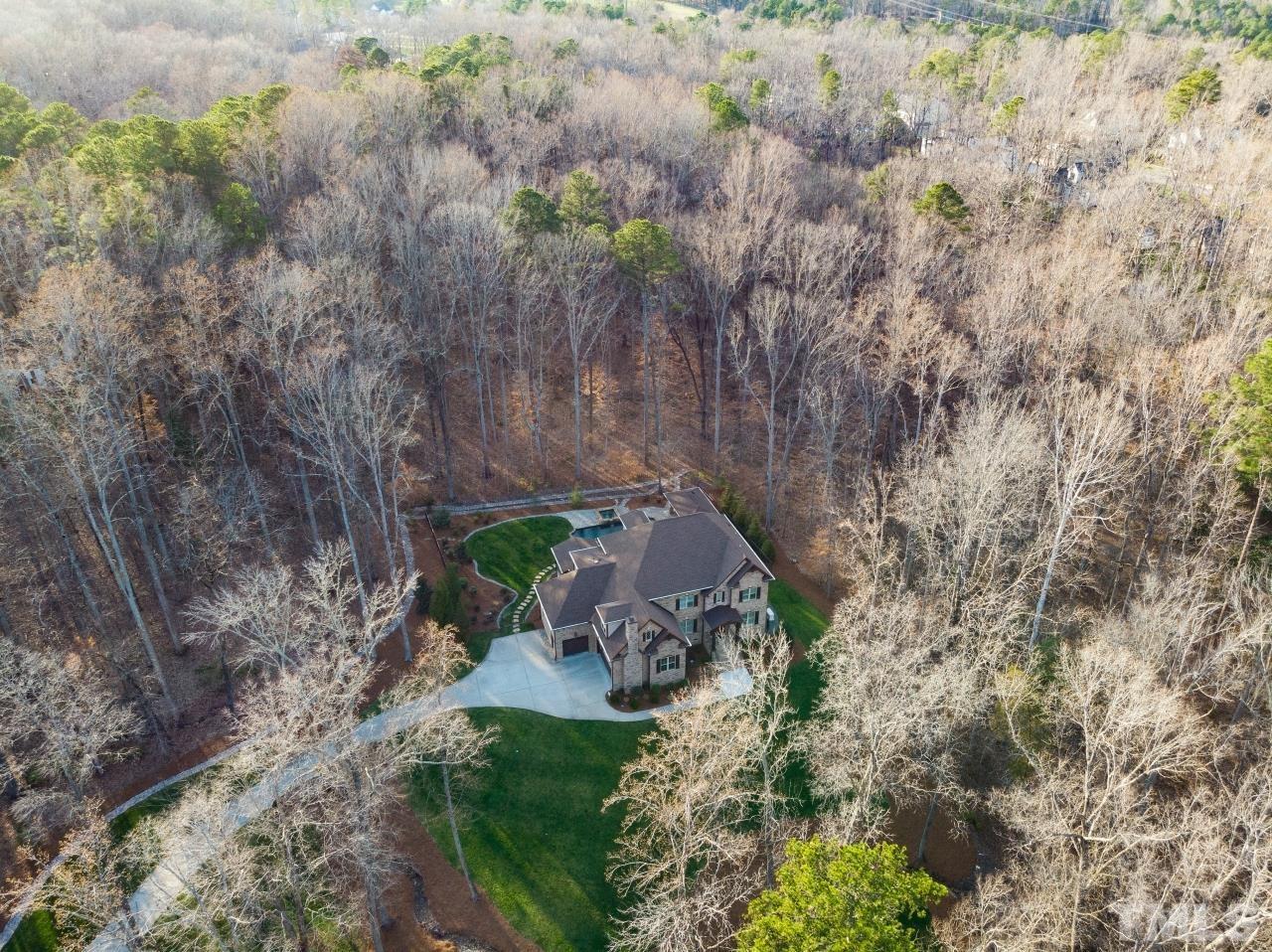 6837 Mactavish Way Raleigh, NC 27613 - Photo 41 of 48 a backyard of a house with a yard and outdoor seating