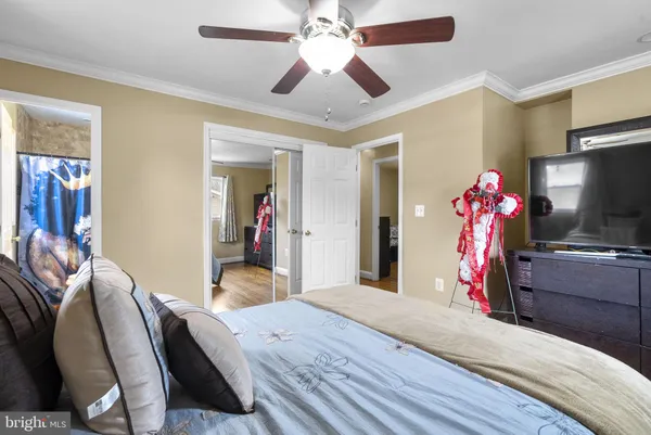 a bedroom with a bed and a flat tv screen