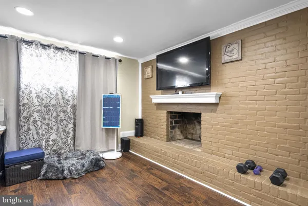 a living room with a fireplace and a flat screen tv