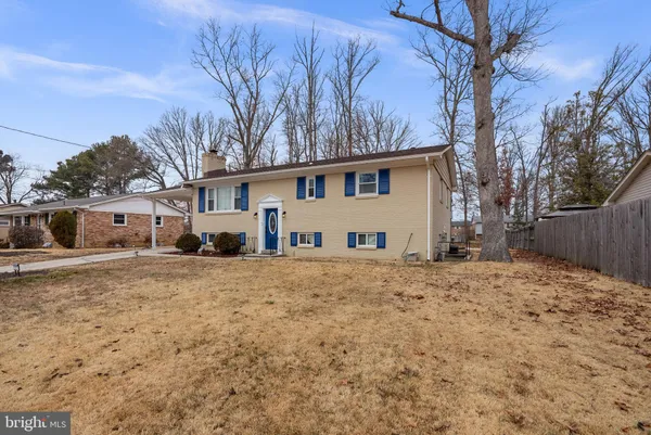 a front view of a house with a yard covered in snow