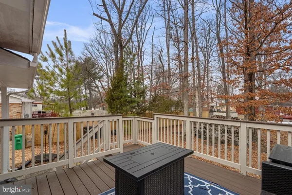 a view of a wooden deck and a yard