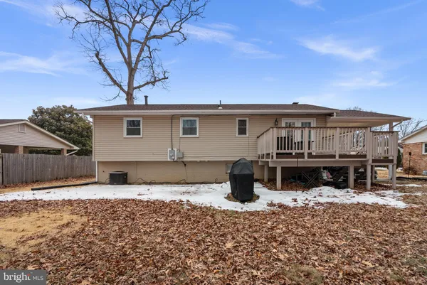 a backyard of a house with fire pit and outdoor seating