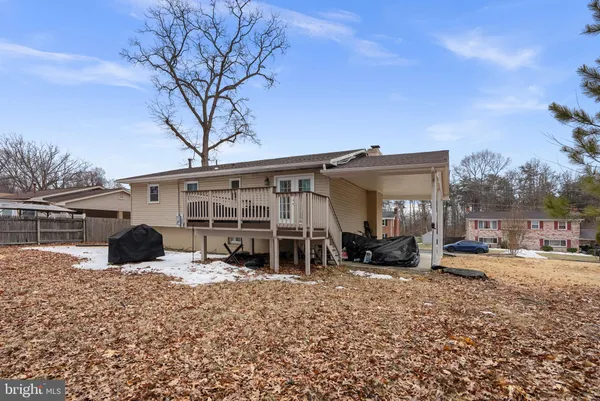 a view of a house with a yard covered in snow