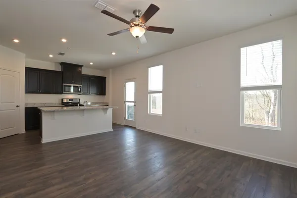 a view of kitchen with refrigerator window and wooden floor