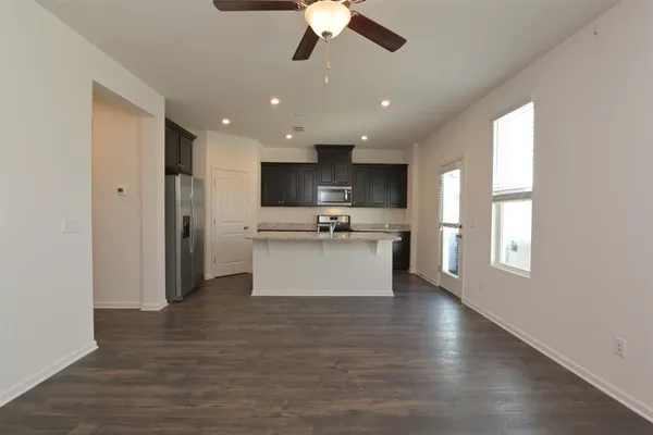 a large kitchen with a large window and stainless steel appliances
