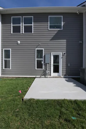 a front view of a house with yard and green space