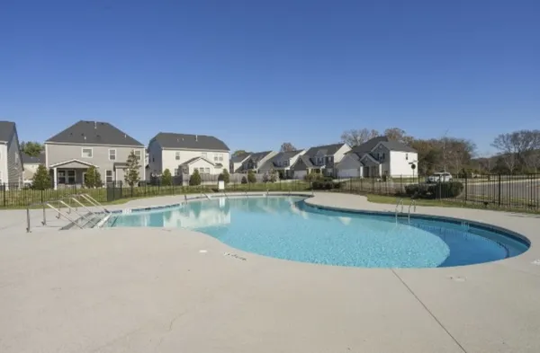a view of house with outdoor space and swimming pool