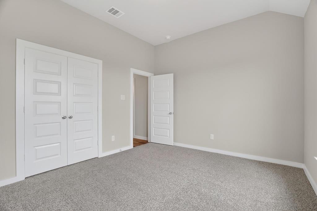 504 Clifton Court Springtown, TX 76082 - Photo 21 of 36 Interior room featuring light gray wall paint and gray carpet flooring