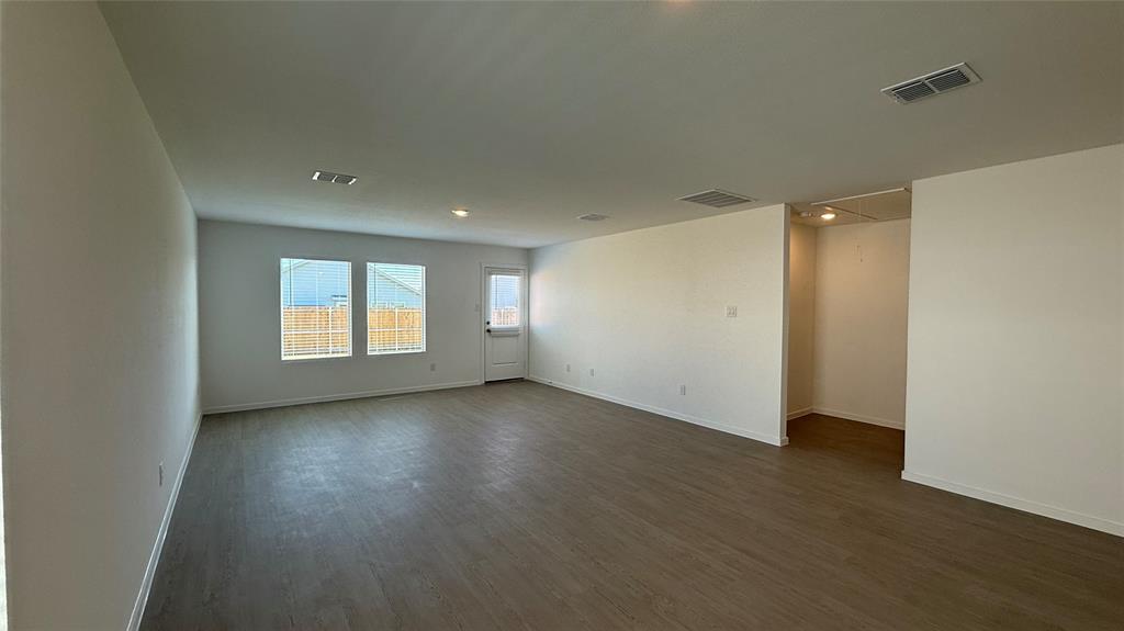6725 Haines Drive Princeton, TX 75407 - Photo 14 of 25 an empty room with wooden floor and windows