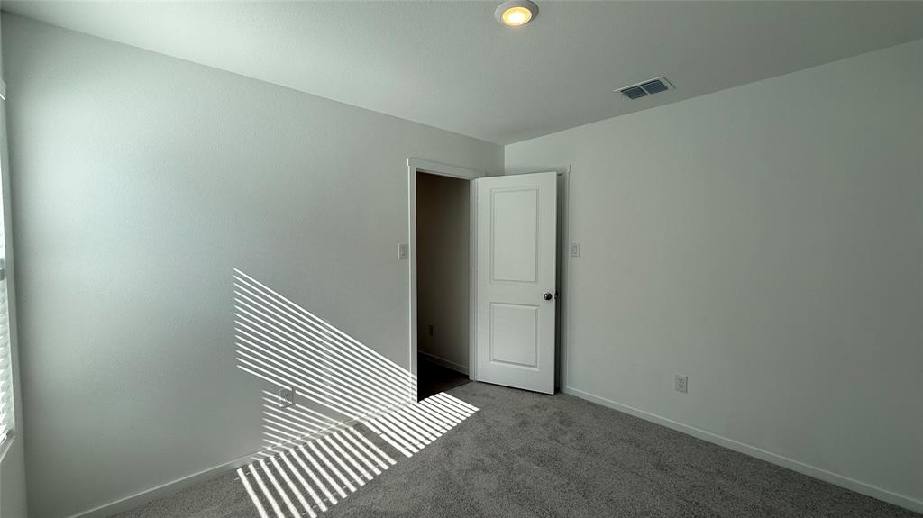 6725 Haines Drive Princeton, TX 75407 - Photo 15 of 25 an empty room with wooden floor and windows