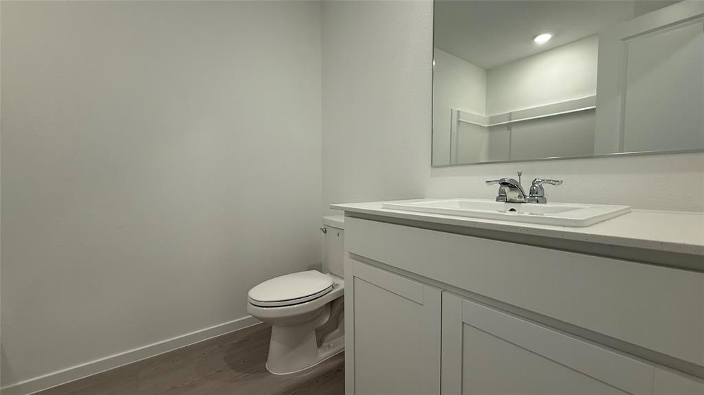 6725 Haines Drive Princeton, TX 75407 - Photo 19 of 25 a bathroom with a sink a toilet and a mirror