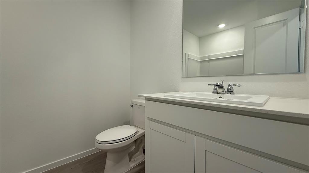 6725 Haines Drive Princeton, TX 75407 - Photo 20 of 25 a bathroom with a sink a toilet and a mirror