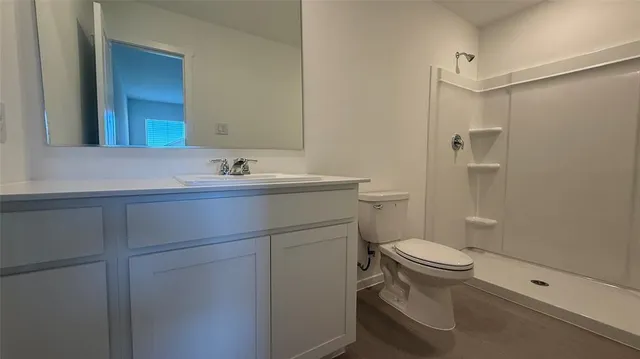 a bathroom with a sink toilet and shower