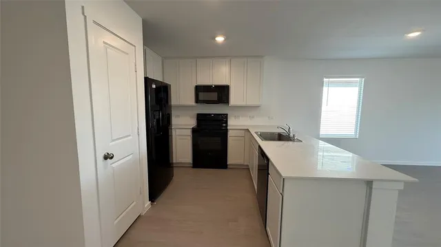 a kitchen with a refrigerator a sink and a stove