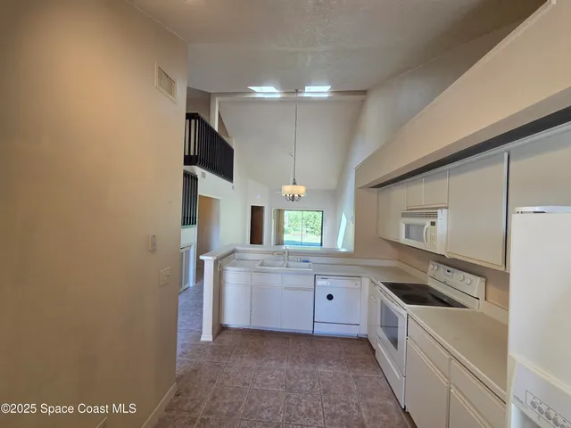 a kitchen with a sink cabinets and stainless steel appliances