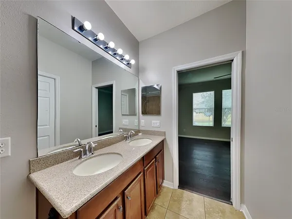 a bathroom with a sink double vanity and a mirror