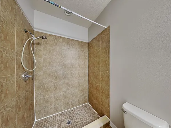 a bathroom with a shower and toilet