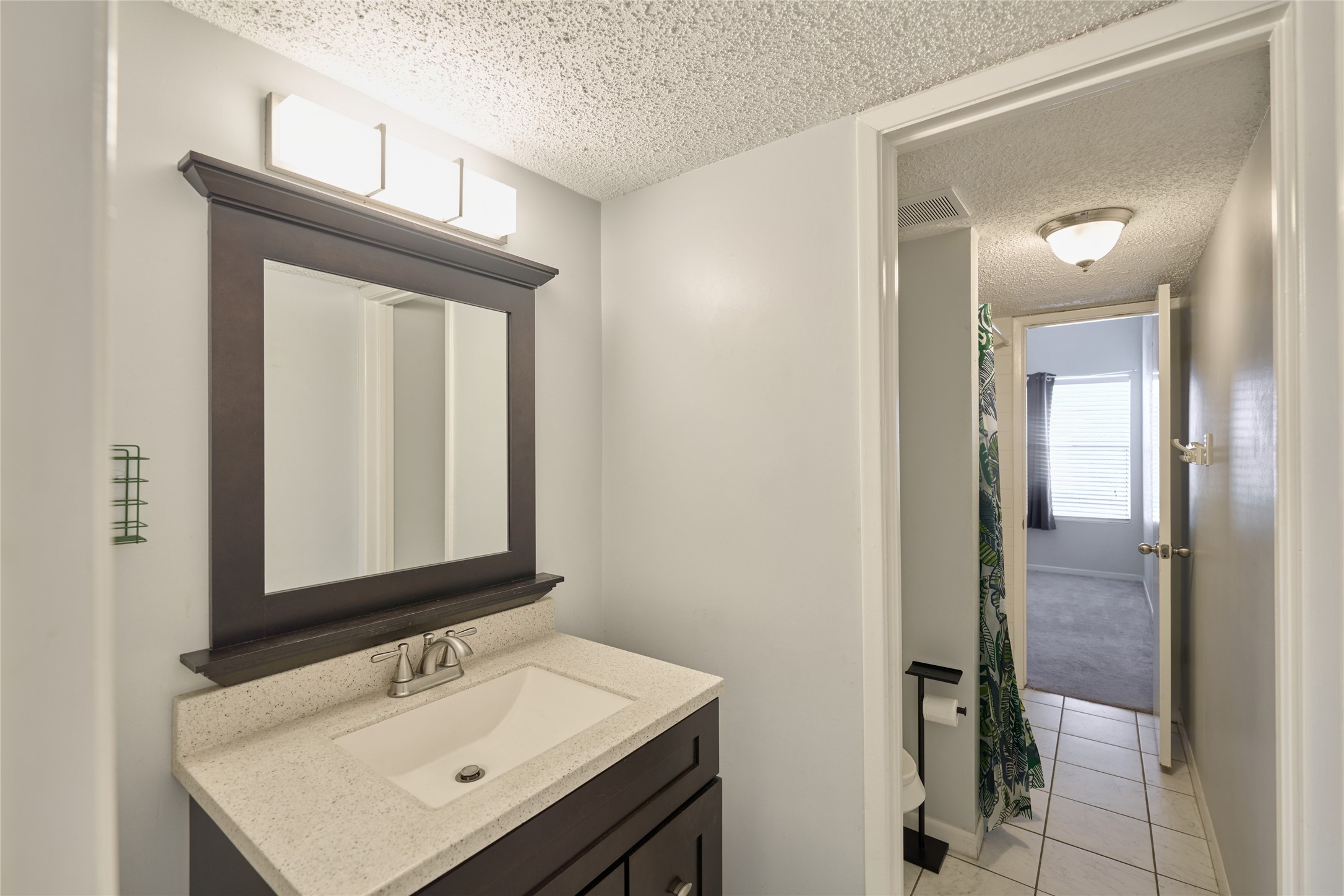 12900 Walden Road, Unit 622F Montgomery, TX 77356 - Photo 17 of 32 a bathroom with a sink a mirror and a shower