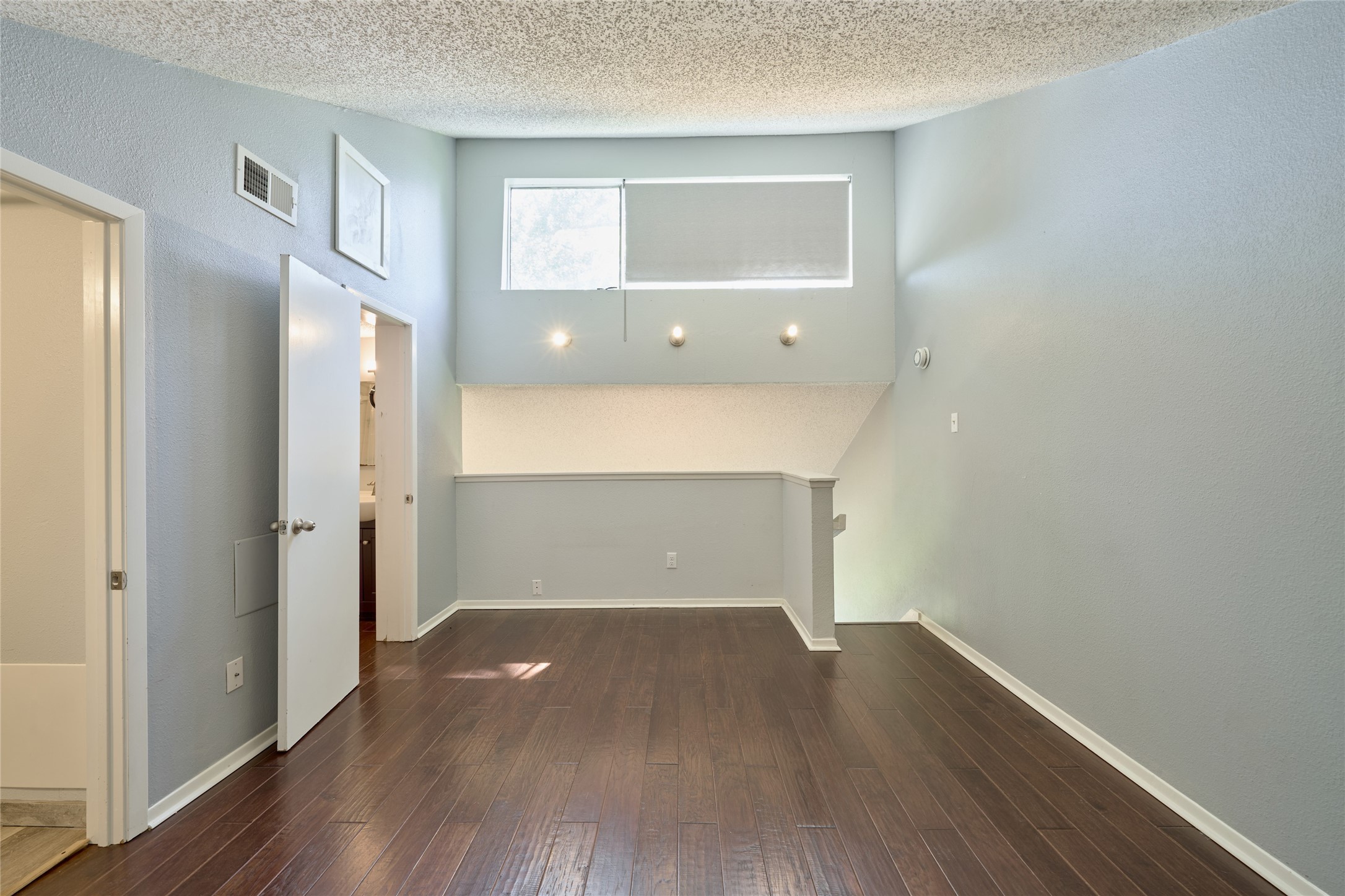 12900 Walden Road, Unit 622F Montgomery, TX 77356 - Photo 21 of 32 wooden floor in an empty room with a window