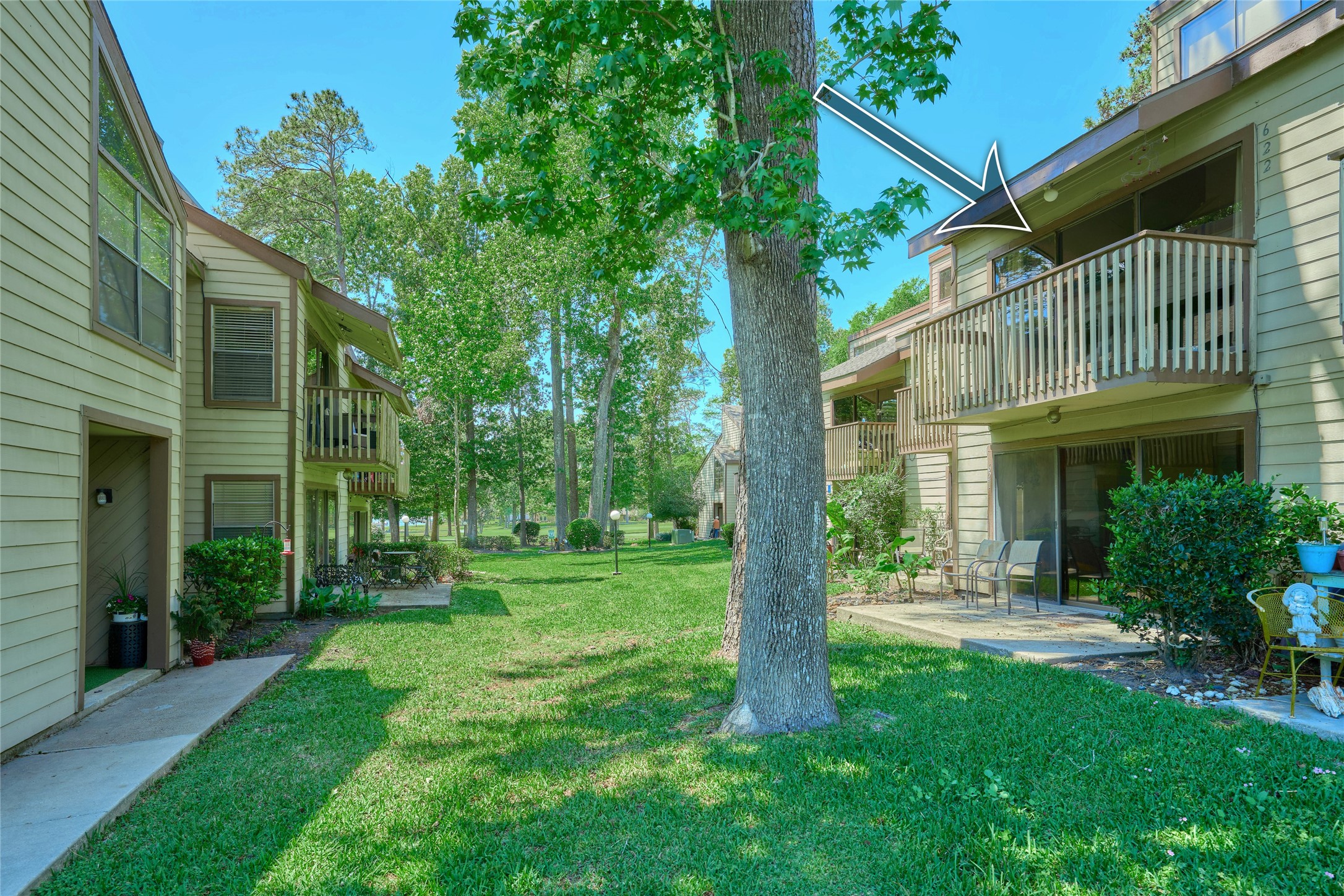 12900 Walden Road, Unit 622F Montgomery, TX 77356 - Photo 26 of 32 a view of a big yard next to a house