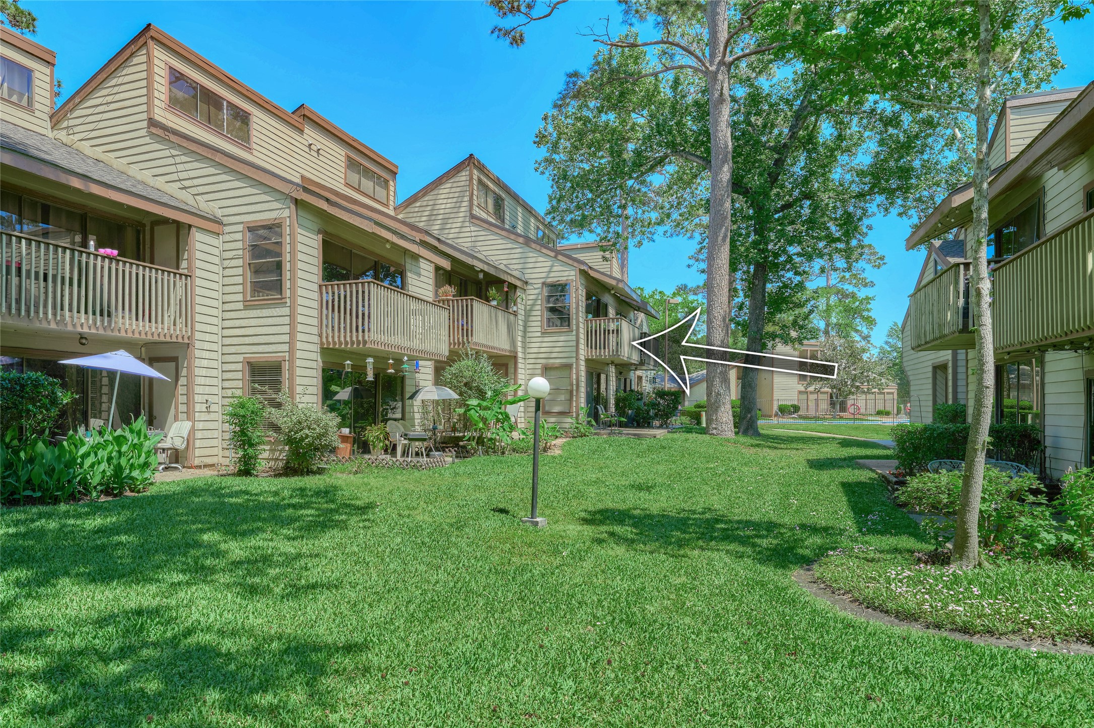 12900 Walden Road, Unit 622F Montgomery, TX 77356 - Photo 31 of 32 a view of a house with a yard and plants